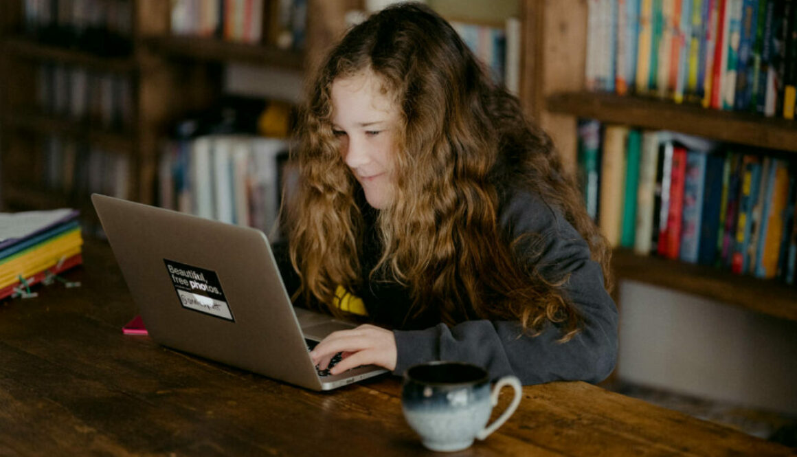 student using laptop in library