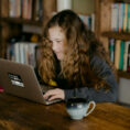 student using laptop in library