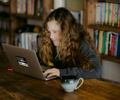 student using laptop in library